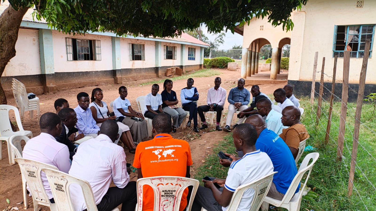 A group seated in a circle for an outdoor fellowship